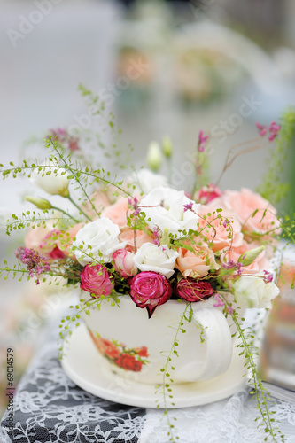 Big cup with roses as decoration