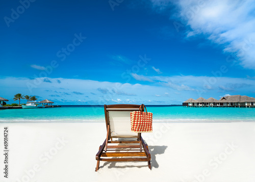 Beach lounger on sand beach