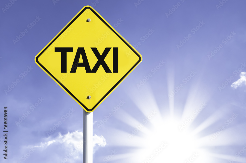 Taxi road sign with sun background