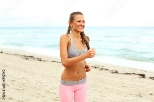 cheerful girl working out on the beach