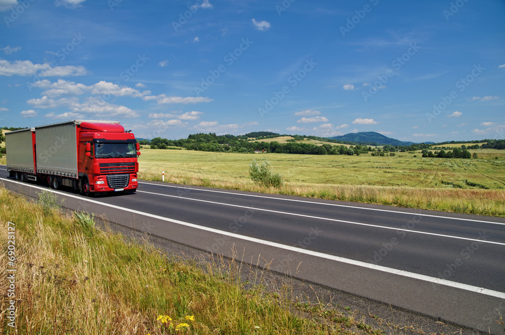 Rural landscape with road you are driving a red truck