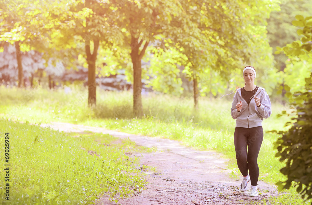 Jogging Sport Concept: Young Running Fitness Woman Training Outd