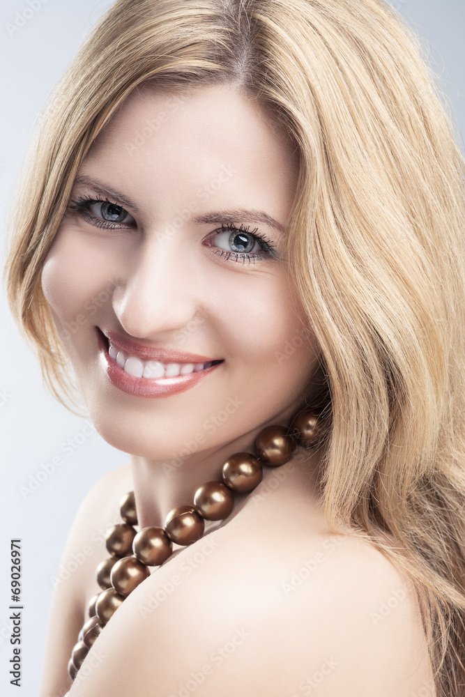 Portrait of Smiling Caucasian Blond Woman Over Gray Studio Backd