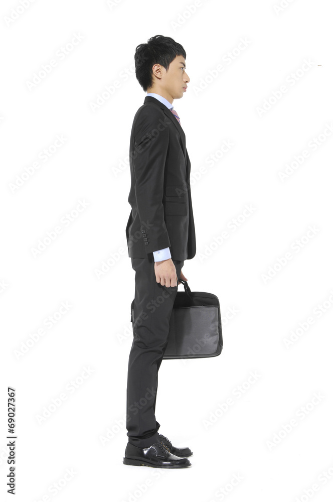 Portrait of a successful young business man carrying a suitcase Portrait of a successful young business man carrying a suitcase