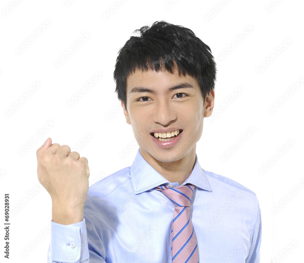 handsome male executive celebrating success with clenched fist handsome male executive celebrating success with clenched fist