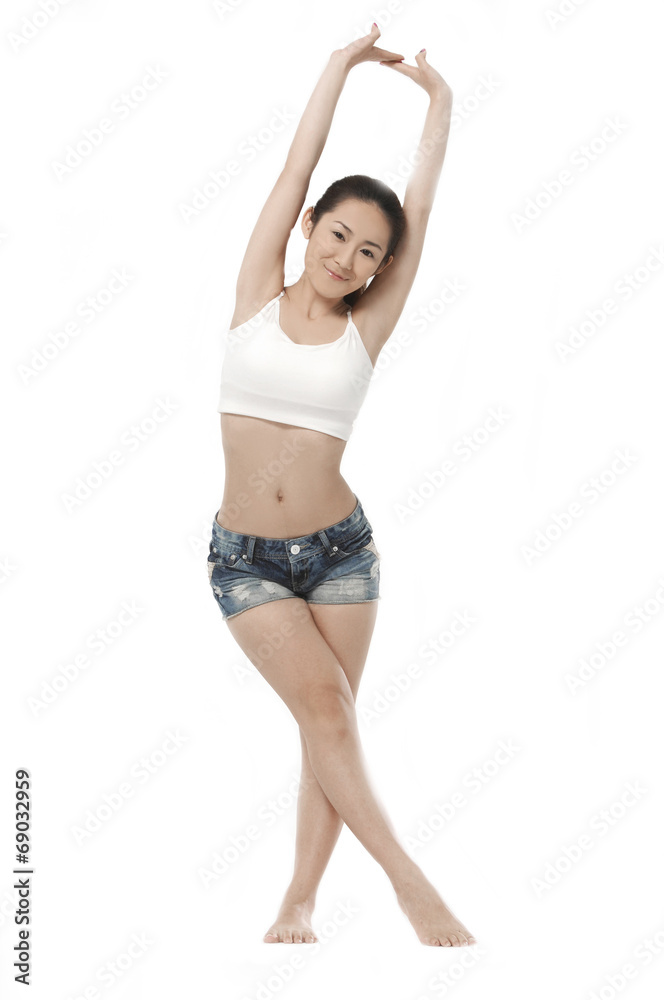 young charming female in shorts stretching her arm young charming female in shorts stretching her arm