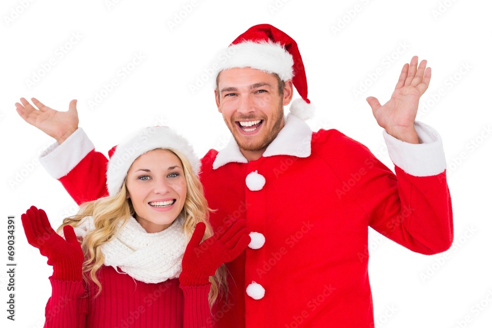 Festive couple smiling with arms raised Festive couple smiling with arms raised