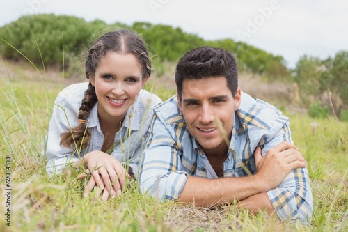 Couple lying on countryside landscape