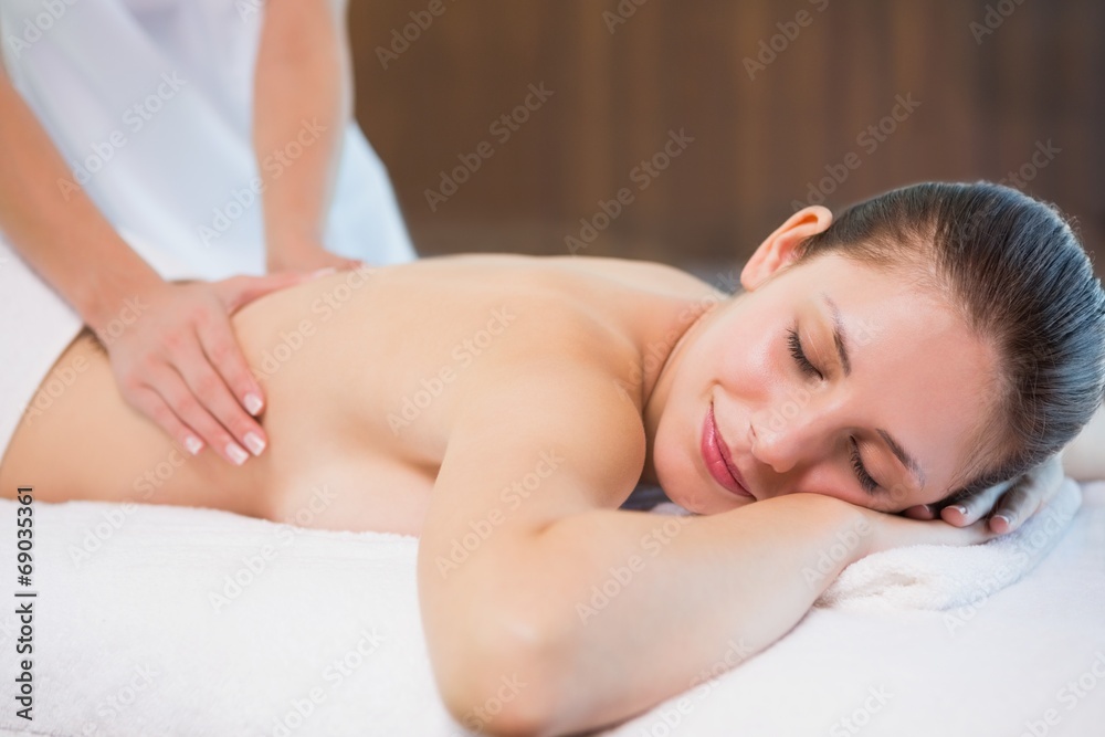 Attractive woman receiving back massage at spa center