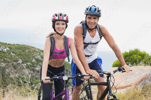 Athletic couple mountain biking