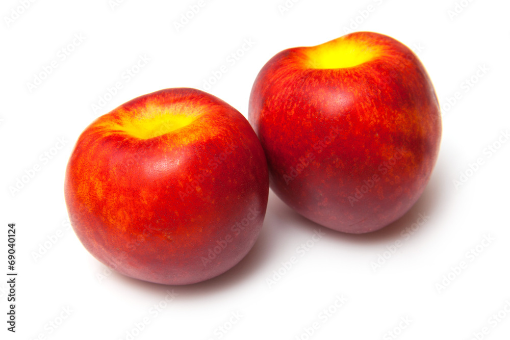 .Nectarines isolated on a white studio background. .Nectarines isolated on a white studio background.