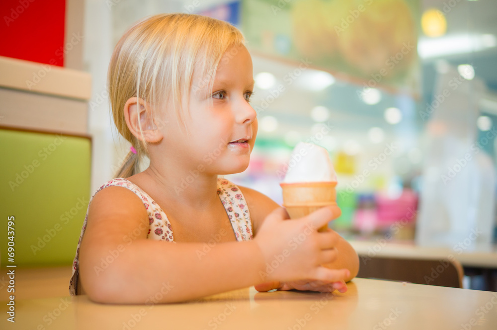 Adorable girl eat fruit ice cream in cafe Adorable girl eat fruit ice cream in cafe