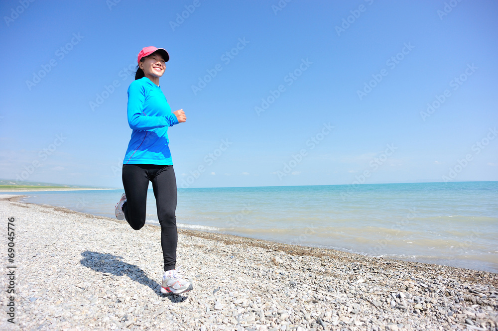 Runner athlete running on stone beach of qinghai lake Runner athlete running on stone beach of qinghai lake