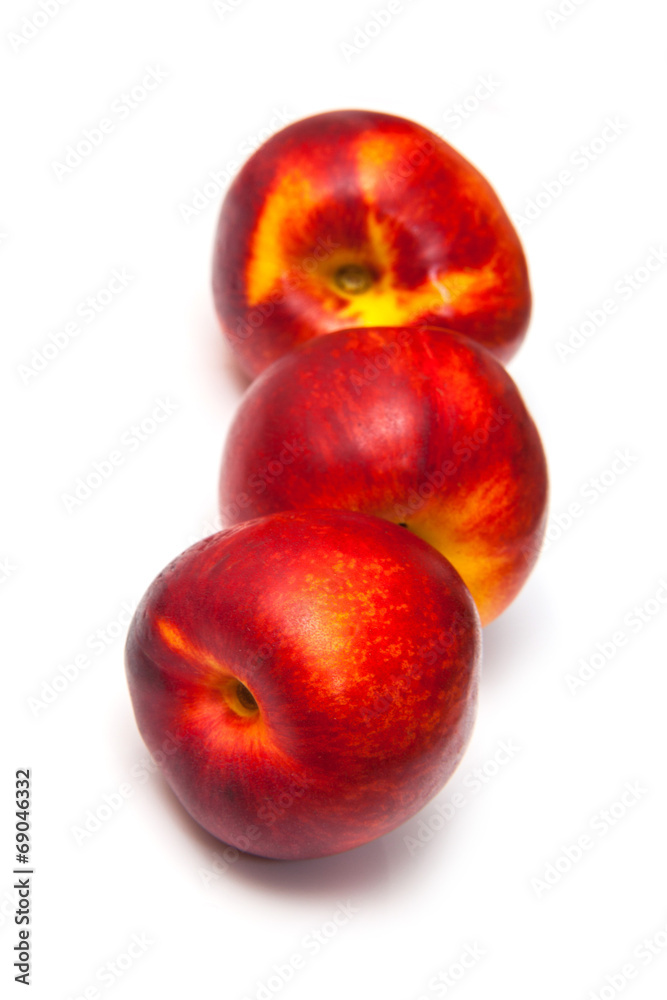 .Nectarines isolated on a white studio background. .Nectarines isolated on a white studio background.