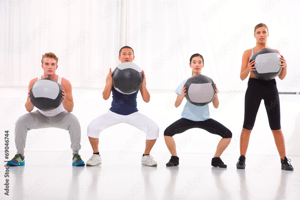 Diverse group of people exercising with pilates in gym Diverse group of people exercising with pilates in gym