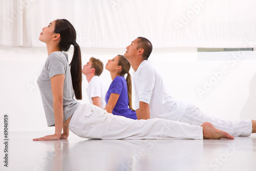 Diverse group of people practicing yoga
