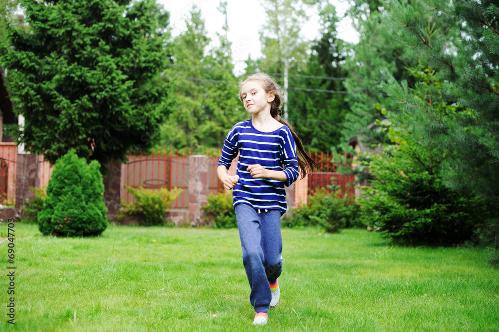 Adorable preteen girl doing exercise outdoors Adorable preteen girl doing exercise outdoors