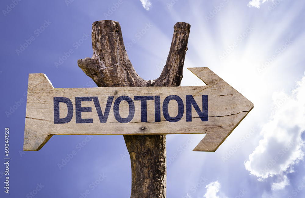 Devotion wooden sign with a street background