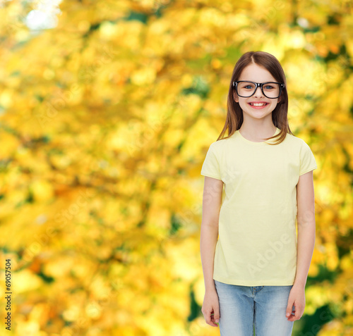 smiling cute little girl in black eyeglasses