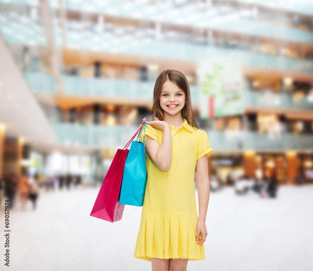 smiling little girl in dress with shopping bags smiling little girl in dress with shopping bags
