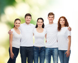 group of smiling teenagers in white blank t-shirts