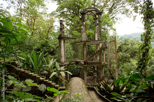 concrete structure with stairs surrounded by jungle photo