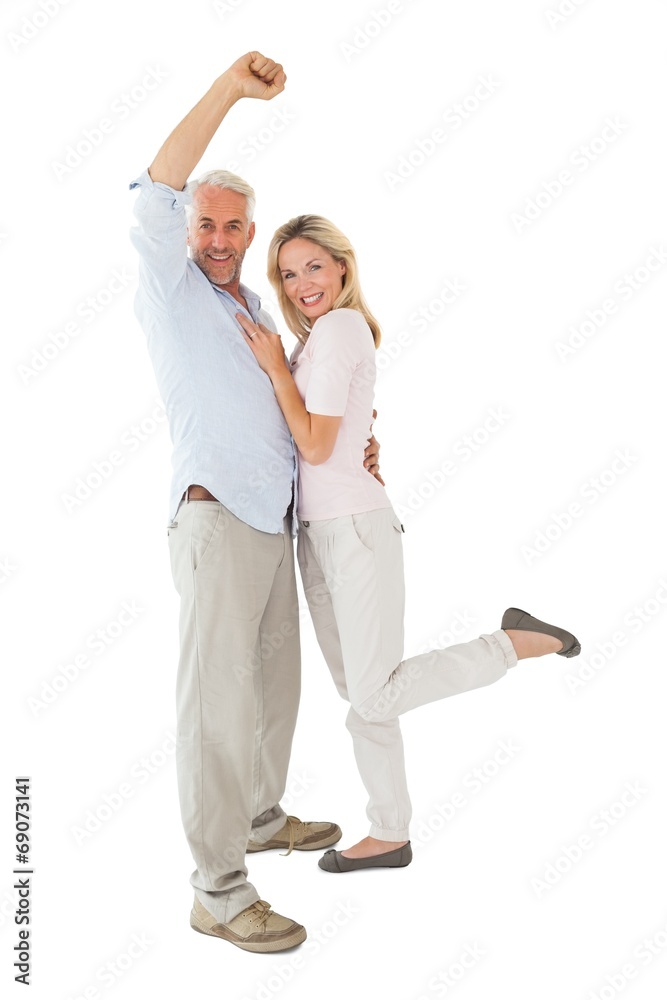 Smiling couple cheering at the camera Smiling couple cheering at the camera