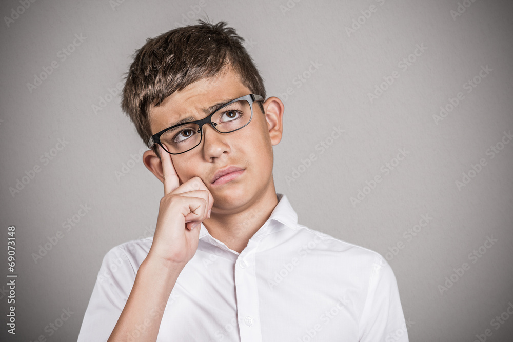 Boy daydreaming, adhd concept, grey wall background Boy daydreaming, adhd concept, grey wall background