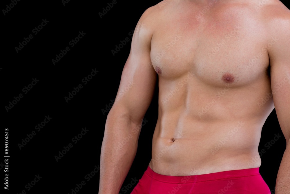 Mid section of a shirtless muscular man