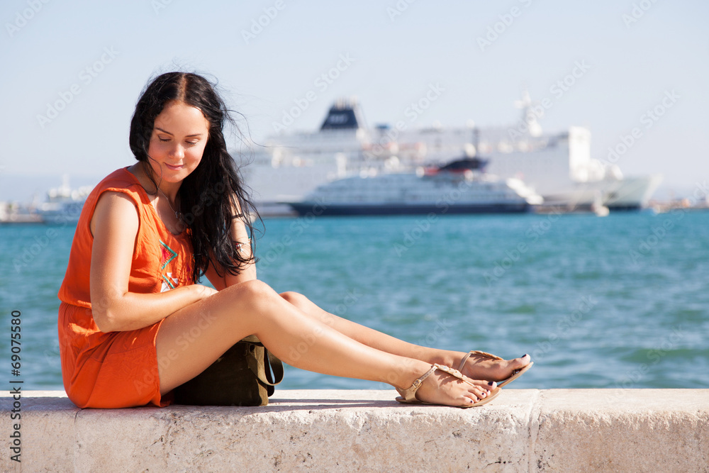 Young beautiful woman at the seaside