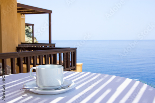 cup of coffee on terrace with sea view