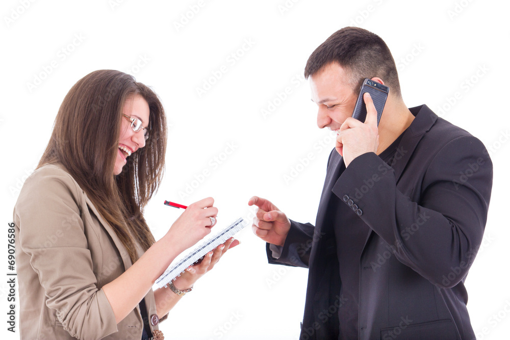 businessman on the phone and his secretary writing down notes businessman on the phone and his secretary writing down notes