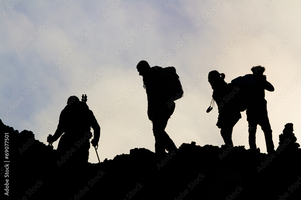 silhouettes of men on the volcano Etna