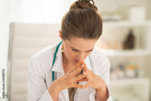 Portrait of concerned doctor woman in office photo