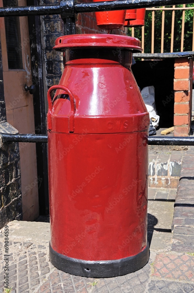 Old Retro red painted milk churn, Bridgnorth. Old Retro red painted milk churn, Bridgnorth.
