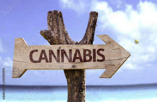 Cannabis wooden sign with a beach on background