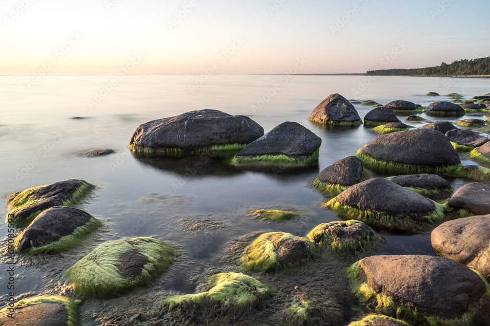 rocky beach at sunset with milky water