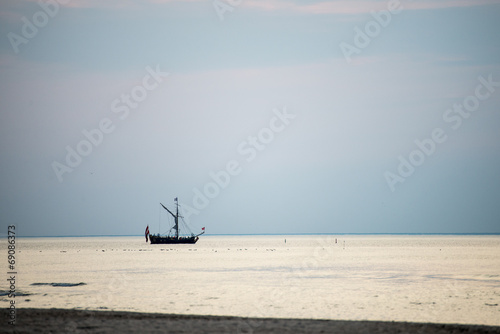 sea with waves and boats before sunset