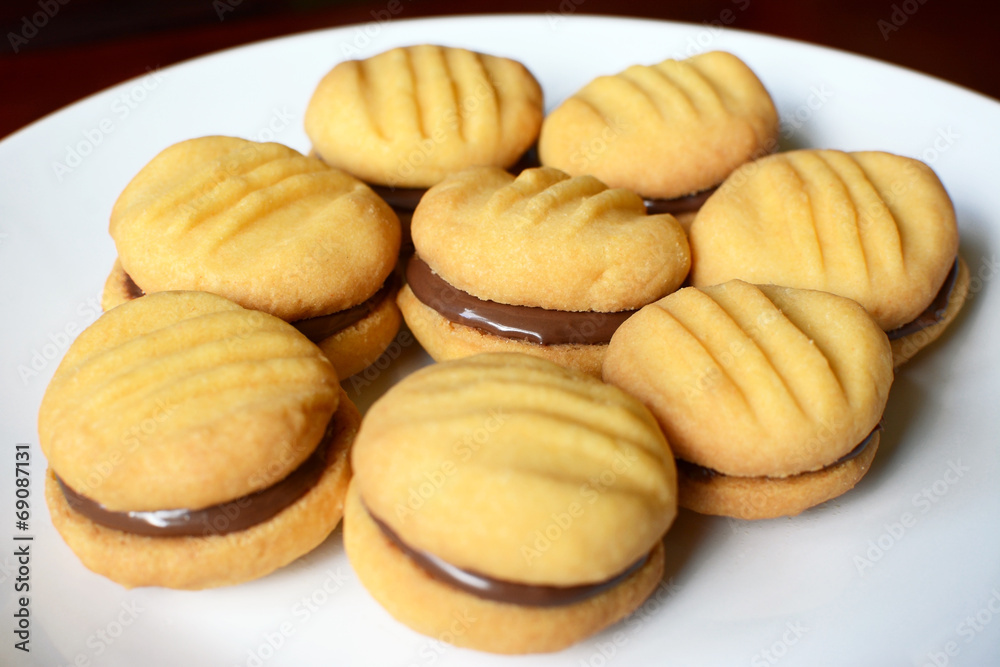 Plate of shortbread biscuits with chocolate filling Plate of shortbread biscuits with chocolate filling