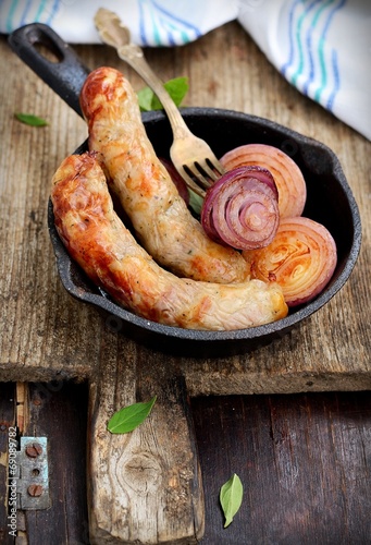 Roasted beef sausages at frying pan