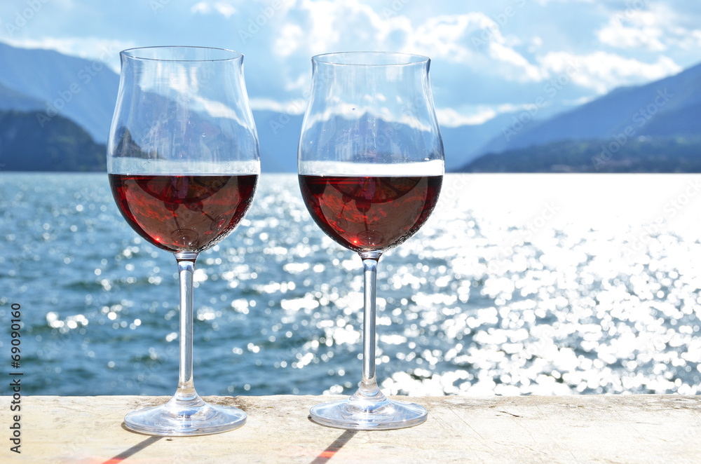 Two wineglasses against lake Como, Italy
