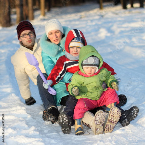 young family sledding