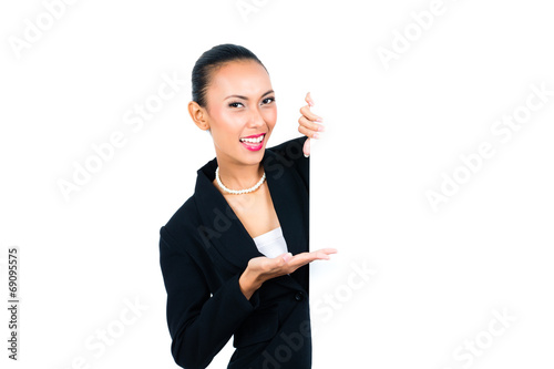 Asian businesswoman showing empty white board