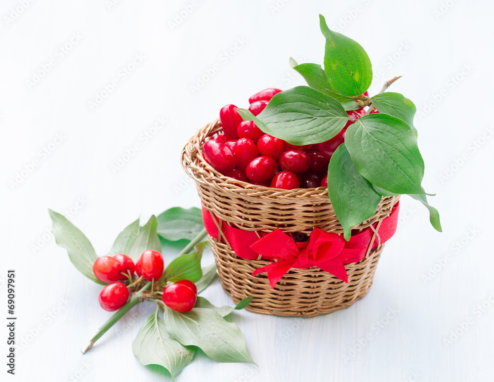 fresh cornel berries on a wooden background