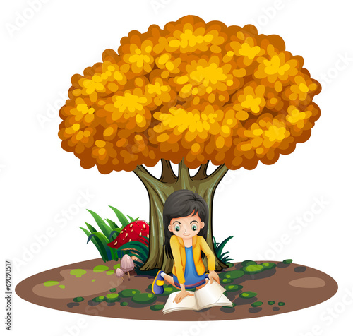 A girl reading under the tree