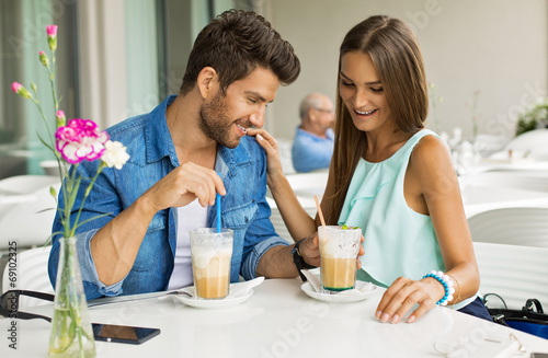Beautiful couple in cafe enjoying the time spending with each ot