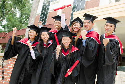 Asian university students celebrate their graduation