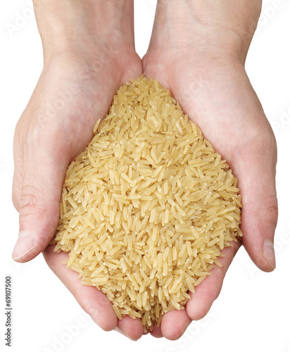 Brown rice in woman's hands on white background