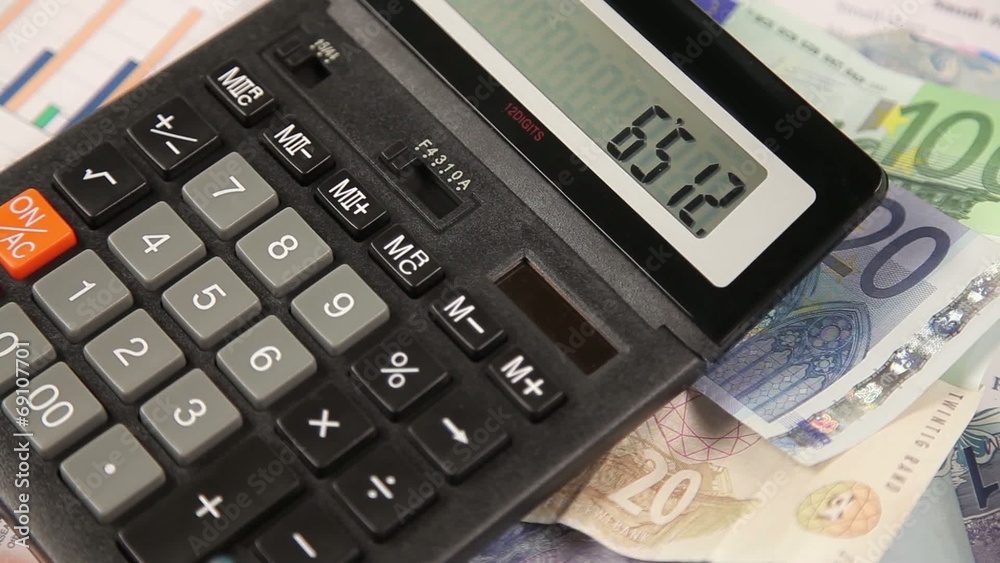 Business man working with calculator in the office Business man working with calculator in the office