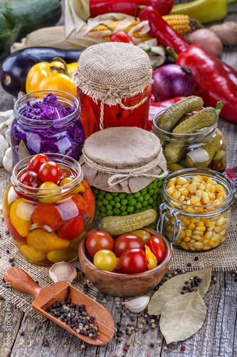 Several kinds of healthy domestic canned vegetables in jars